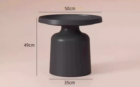 A sleek matte black ceramic coffee table with rounded top and flared base from the lucas coffee table set