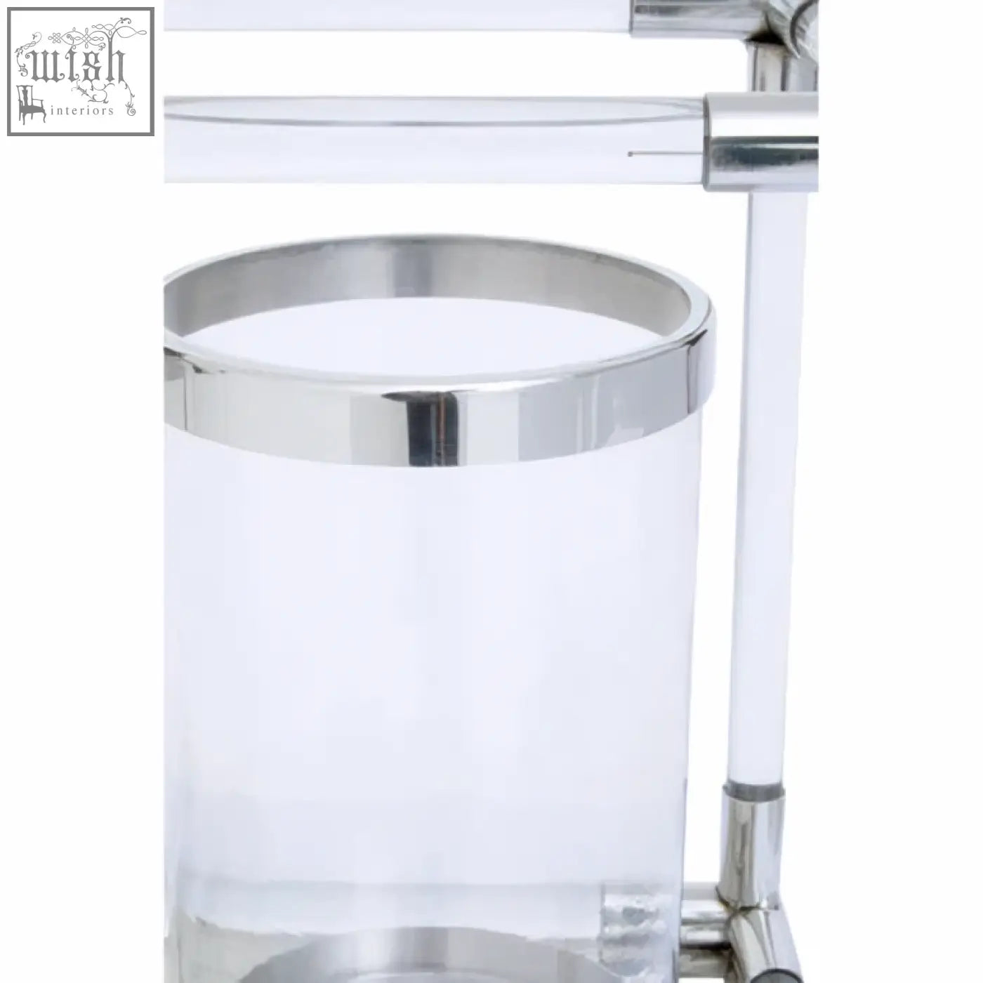 Clear acrylic trash can with polished chrome rim and base next to lucita double silver steel candle holder