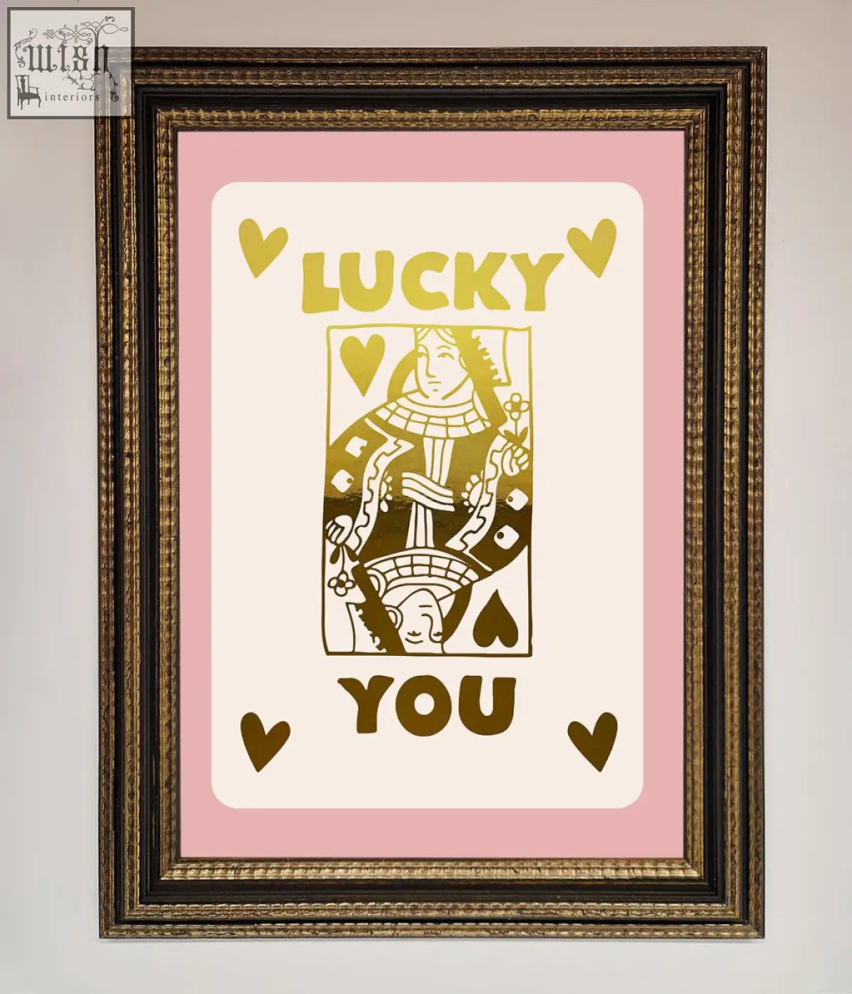 A framed lucky you foil print featuring a queen of hearts design with gold lettering on pink with quick shipping times