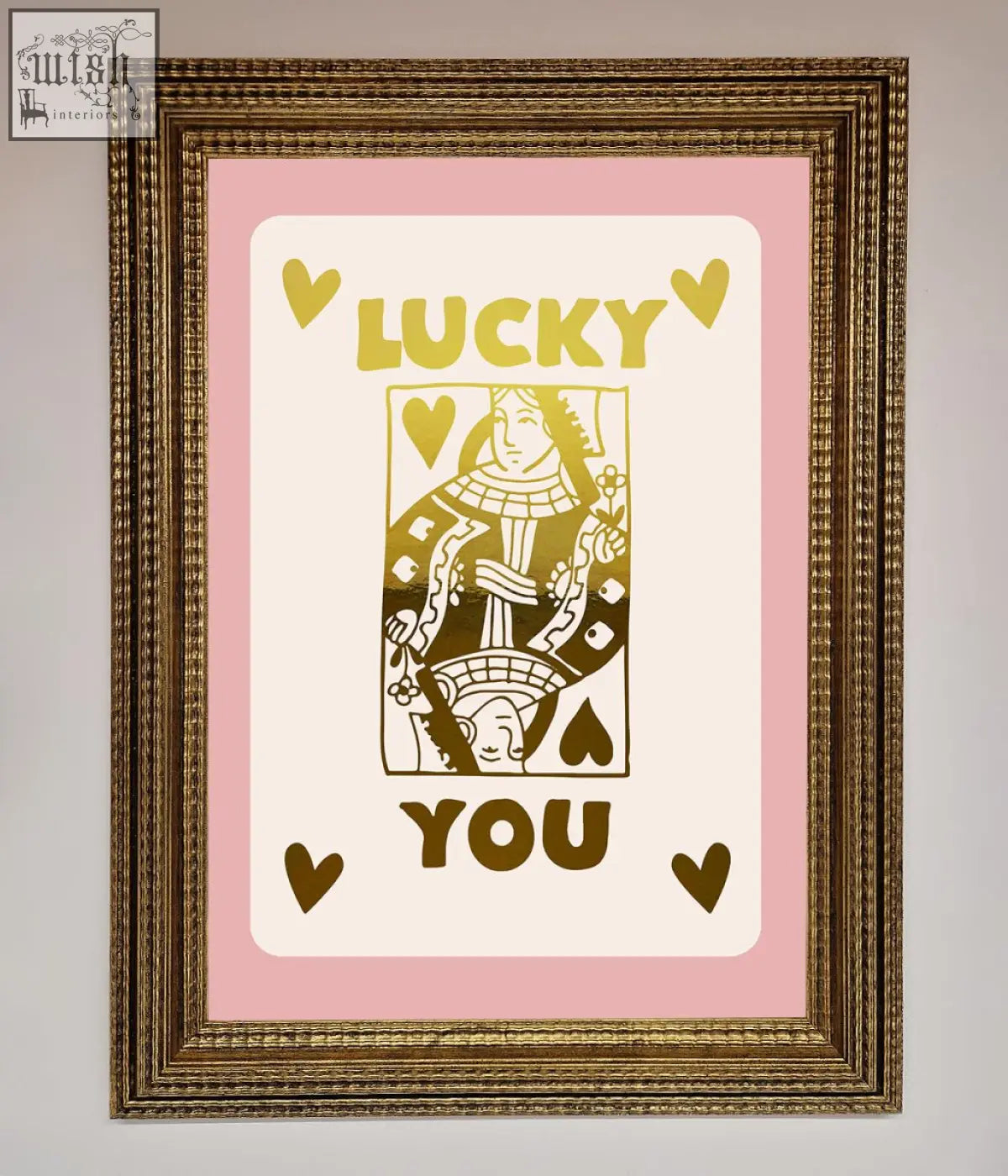 A framed lucky you foil print with a gold-inked queen of hearts card on a soft pink background perfect for quick shipping times