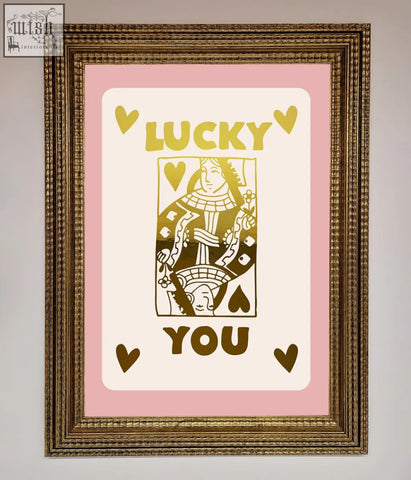A framed lucky you foil print with a gold-inked queen of hearts card on a soft pink background perfect for quick shipping times