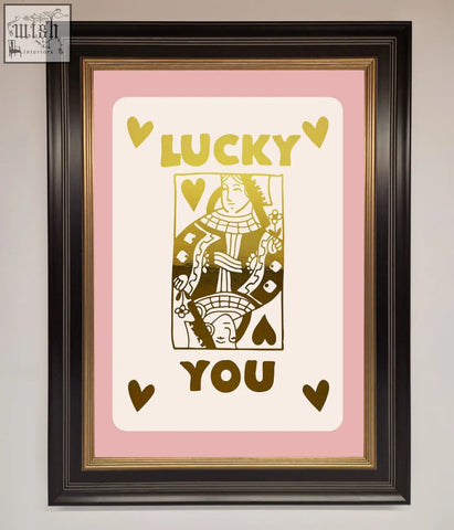 A lucky you foil print featuring a queen of hearts design in gold foil on pink with a black and gold frame, fast shipping times
