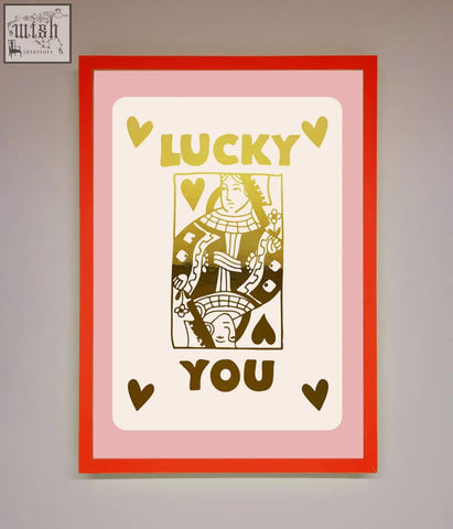A lucky you foil print featuring a queen playing card with gold lettering in a red frame with pink border perfect for fast shipping times