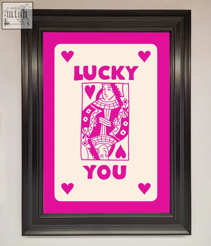Framed pink and white lucky you playing card art with a stylized queen of hearts in a hot pink framed poster