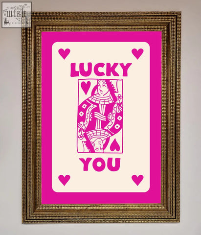 Hot pink framed poster featuring a pink cream queen of hearts design with lucky you text in an ornate gold frame