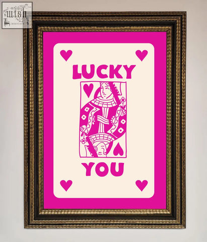 A hot pink framed poster featuring a vibrant pink and cream lucky you queen playing card design on off-white background