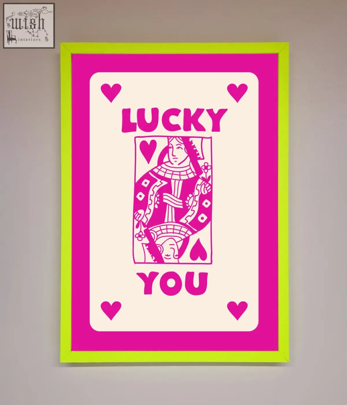 A vibrant hot pink framed poster with a neon green frame featuring a pink and cream lucky you playing card design