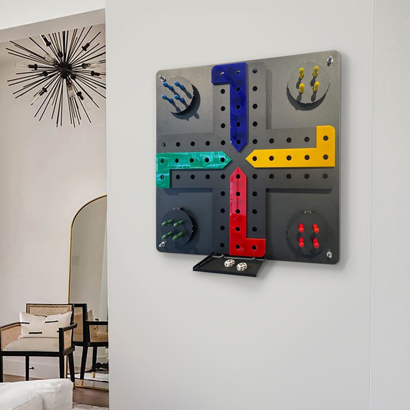 A modern ludo wall game with a sleek gray base and vibrant blue yellow red green paths with matching pegs and hanging instructions