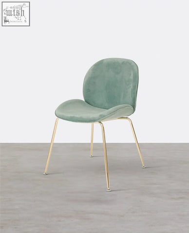 Mint green velvet lule dining chair with slender gold metal legs perfect for stylish dining spaces
