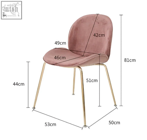 A soft pink velvet lule dining chair with slender painted steel gold legs perfect for stylish dining spaces