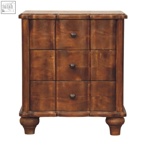Antique-style wooden lume panel bedside table with three drawers and round dark metal knobs on turned legs