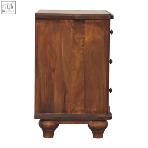 Rustic brown wooden lume panel bedside table with three drawers and black round knobs on turned legs