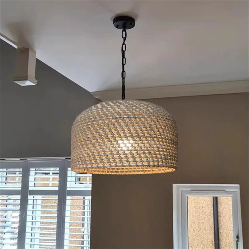 A woven beige rattan luna light pendant with a black metal chain and ceiling mount for stylish lighting