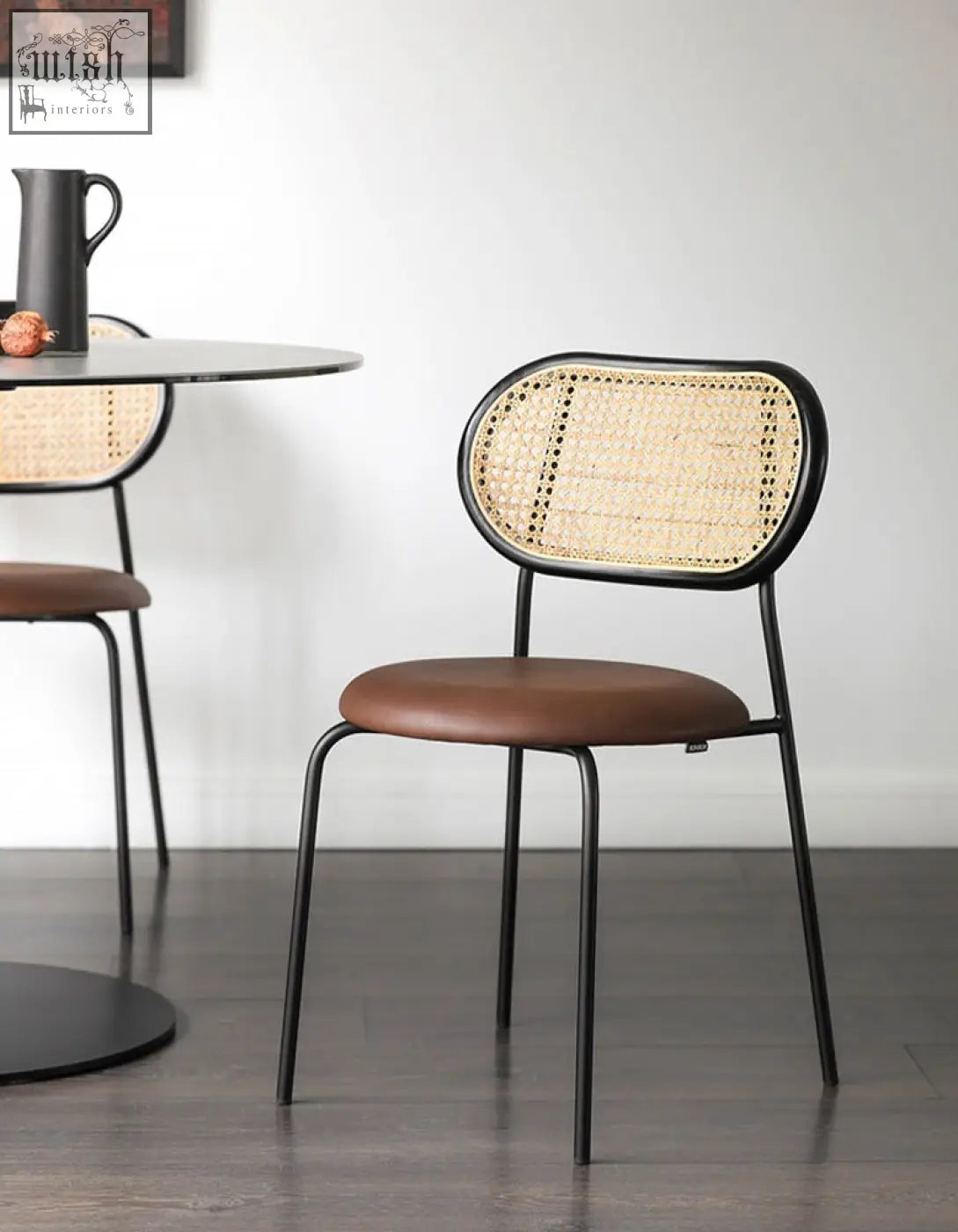 Black metal frame luna dining chair with woven cane back and brown leather seat perfect as a rattan dining chair