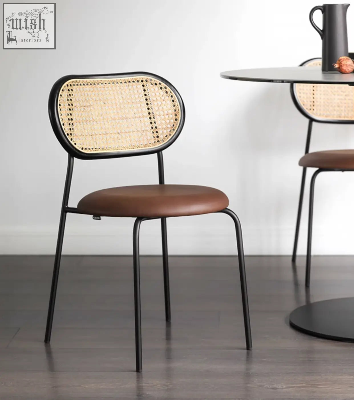 Black metal frame luna dining chair with woven rattan back and brown leather seat for dining room use