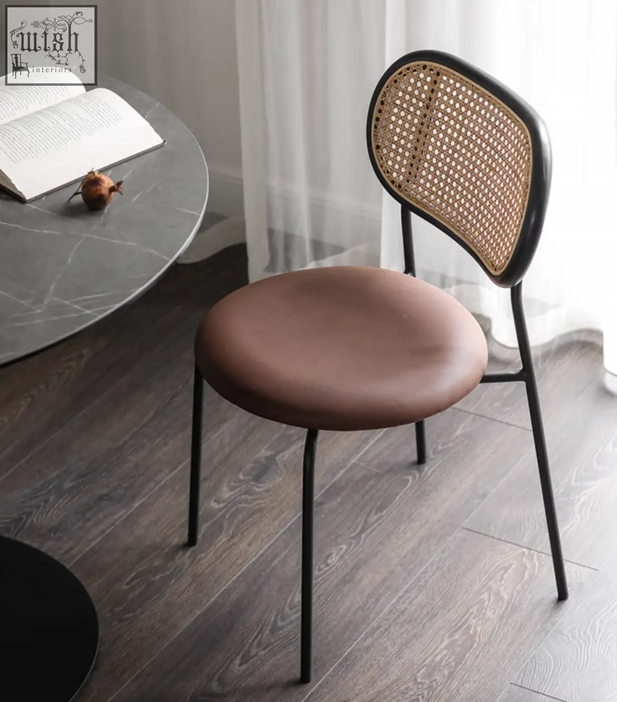 Modern luna rattan dining chair with black metal frame, woven cane backrest, and brown oak upholstered seat