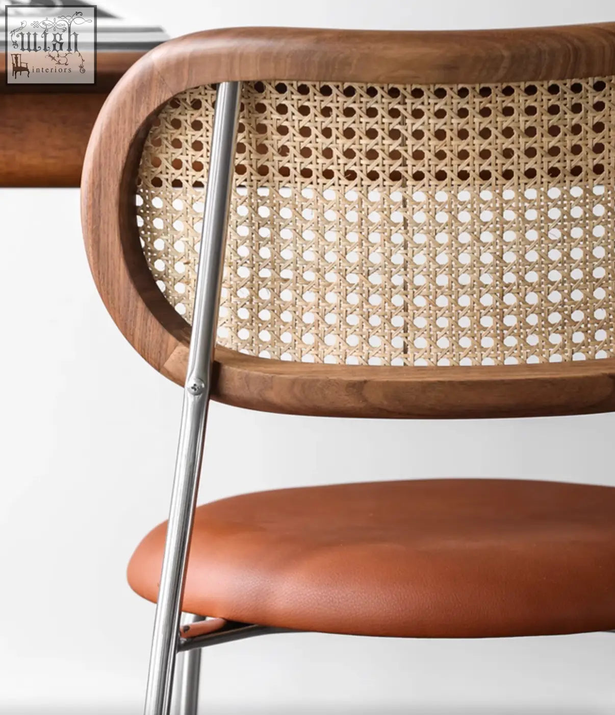 Modern luna dining chair with curved oak frame, rattan backrest, brown leather seat, and sleek chrome legs