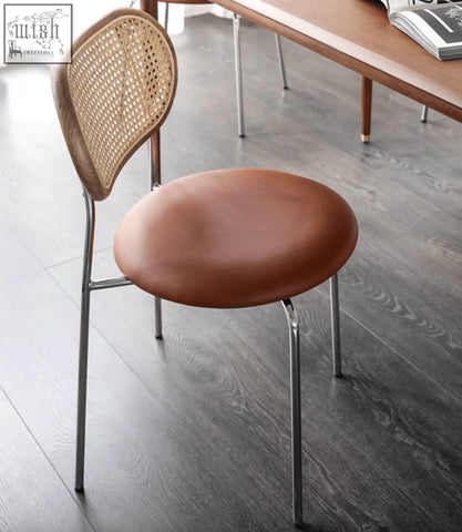 Luna rattan dining chair with woven cane backrest brown leather seat and chrome legs perfect for dining spaces