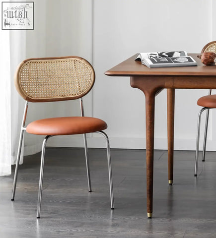 Modern luna dining chair with woven rattan back, brown leather seat, and chrome legs for stylish dining room seating