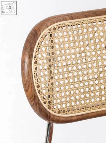 Back of a luna rattan dining chair with oval cane design warm walnut wood frame and natural rattan dining weave