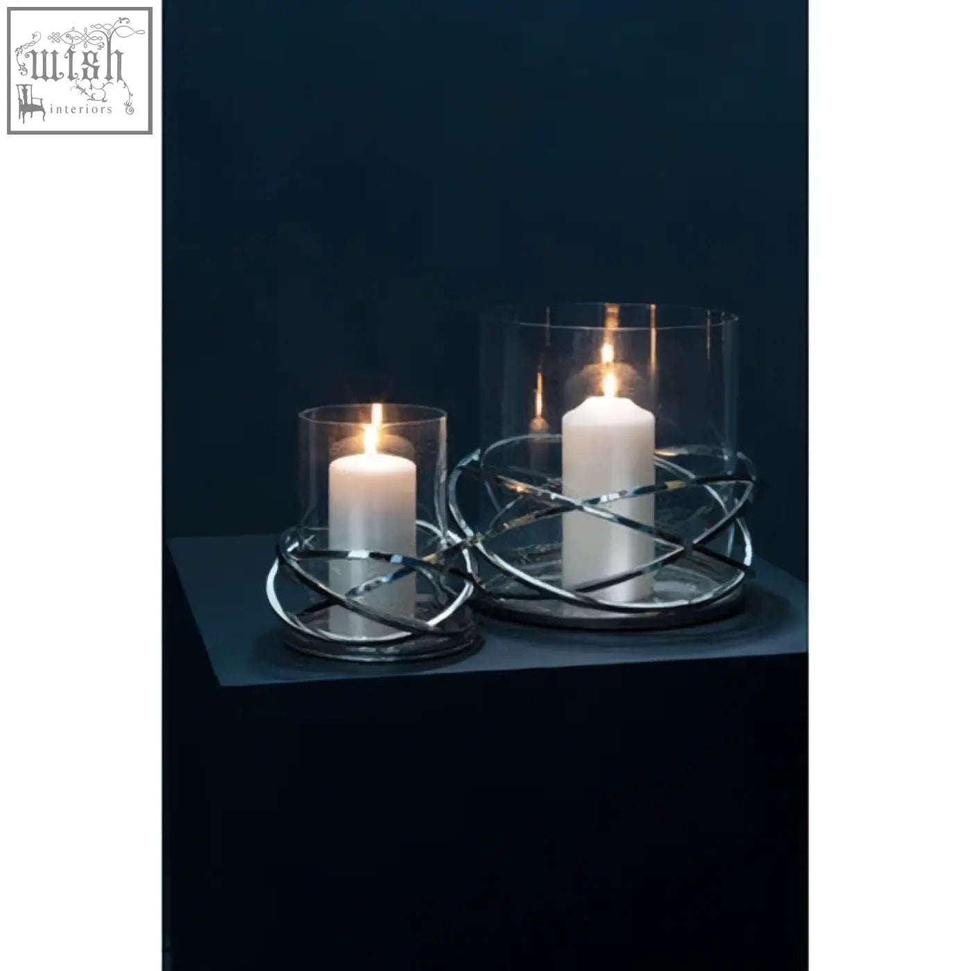 Silver finish twist small silver wire candle holder with clear glass tops holding white pillar candles