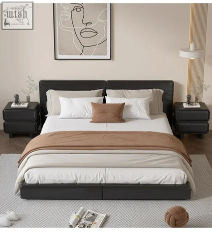 Black leather platform bed with tufted headboard and white bedding near a solid wood bedside table with moroccan design