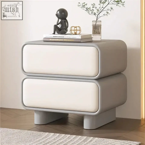 Modern two-drawer bedside table with sleek gray and white faux leather and solid wood legs in moroccan design style