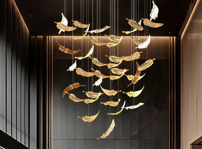 A luxury glass led chandelier with golden and white feather-shaped glass panels hanging elegantly from above