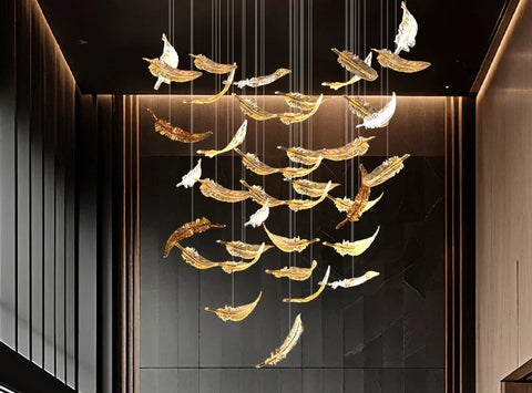 A luxury glass led chandelier with golden and white feather-shaped glass panels hanging elegantly from above