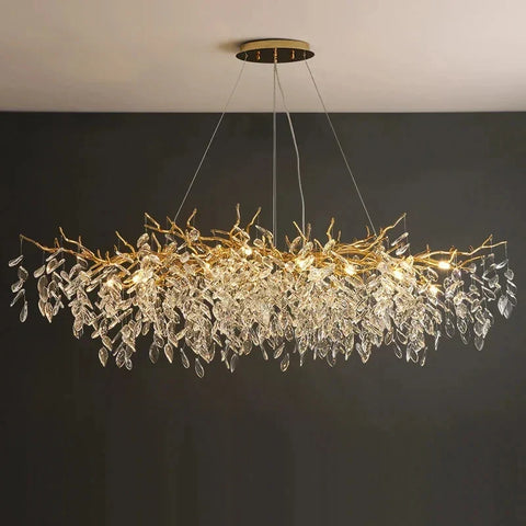 Gold-toned chandelier with intricate branch metalwork and clear crystal leaves perfect for indoor villa lights fixture