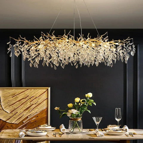 A golden branch-like chandelier with clear crystal leaves perfect as indoor villa lights fixture for elegant villa decor