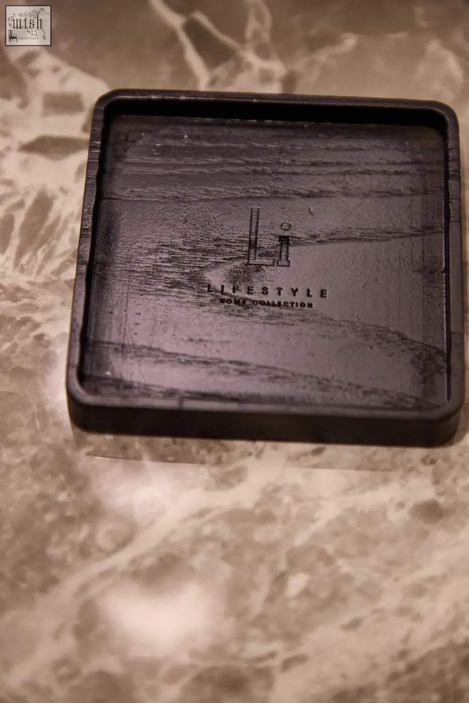 Black rectangular wood grain coaster with embossed lifestyle branding for luxury square diffuser amber