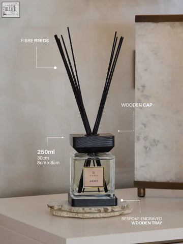 A sleek 250ml glass luxury square diffuser with black wooden cap and base featuring li home amber scent