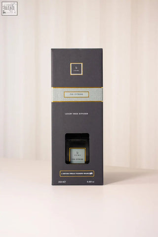 Dark gray rectangular luxury reed diffuser box with gold-trimmed fig citrine label for elegant home scenting
