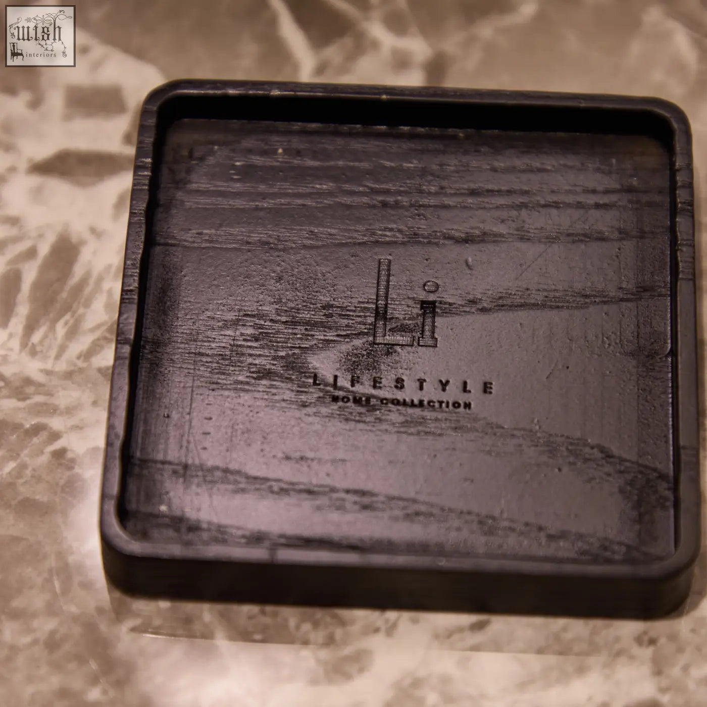 Black rectangular wooden coaster with subtle grain and lifestyle home collection engraving for luxury square diffuser musk