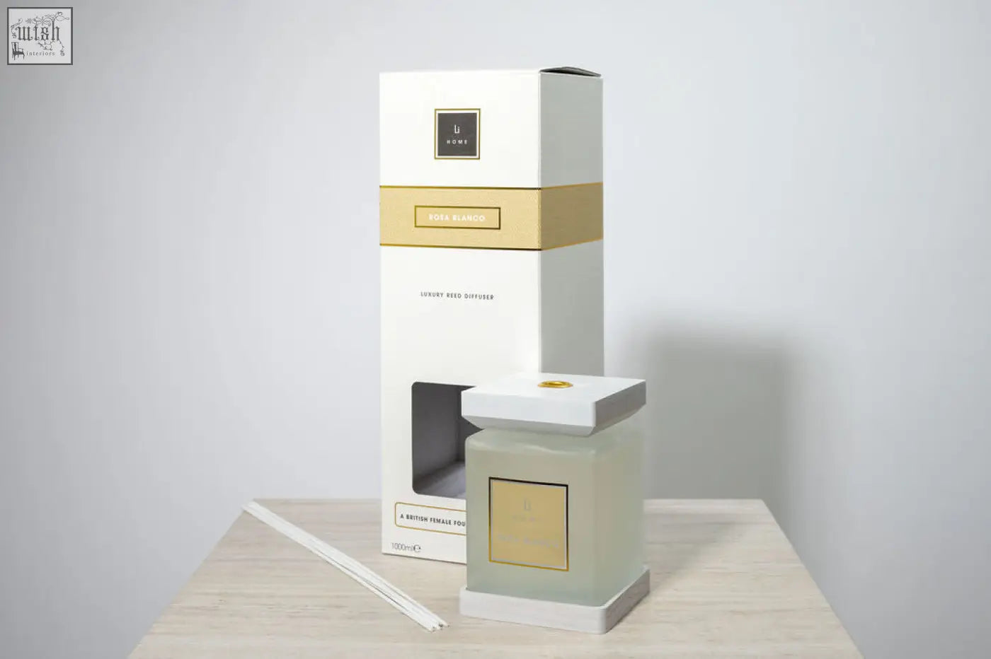 A sleek frosted glass luxury square diffuser rosa blanco with white rose scent and minimalist gold accents and box