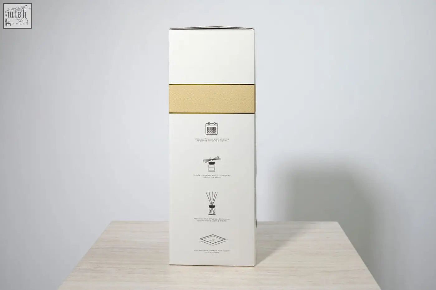 A sleek white rectangular luxury square diffuser box with gold band and minimalist line art for rosa blanco white rose