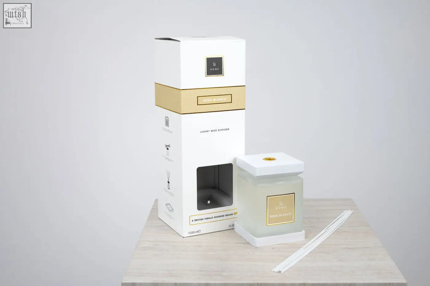 Luxury square diffuser rosa blanco with frosted glass, gold label, and minimalist white rose packaging with gold accents
