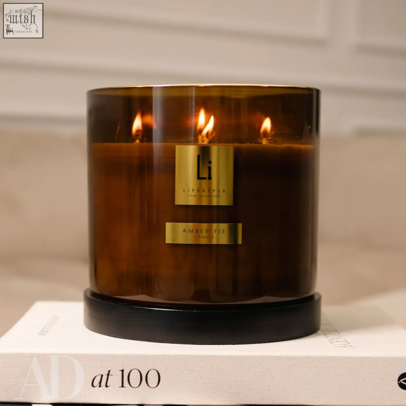 Amber fie luxury xxl candle with amber glass jar gold labels and black base featuring three wick design