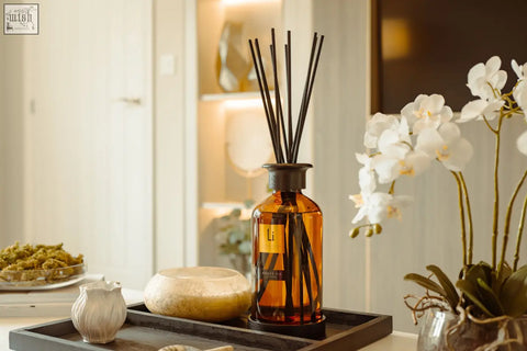 Amber fie luxury xxl room diffuser in amber glass with dark brown reeds and a gold label for home fragrance