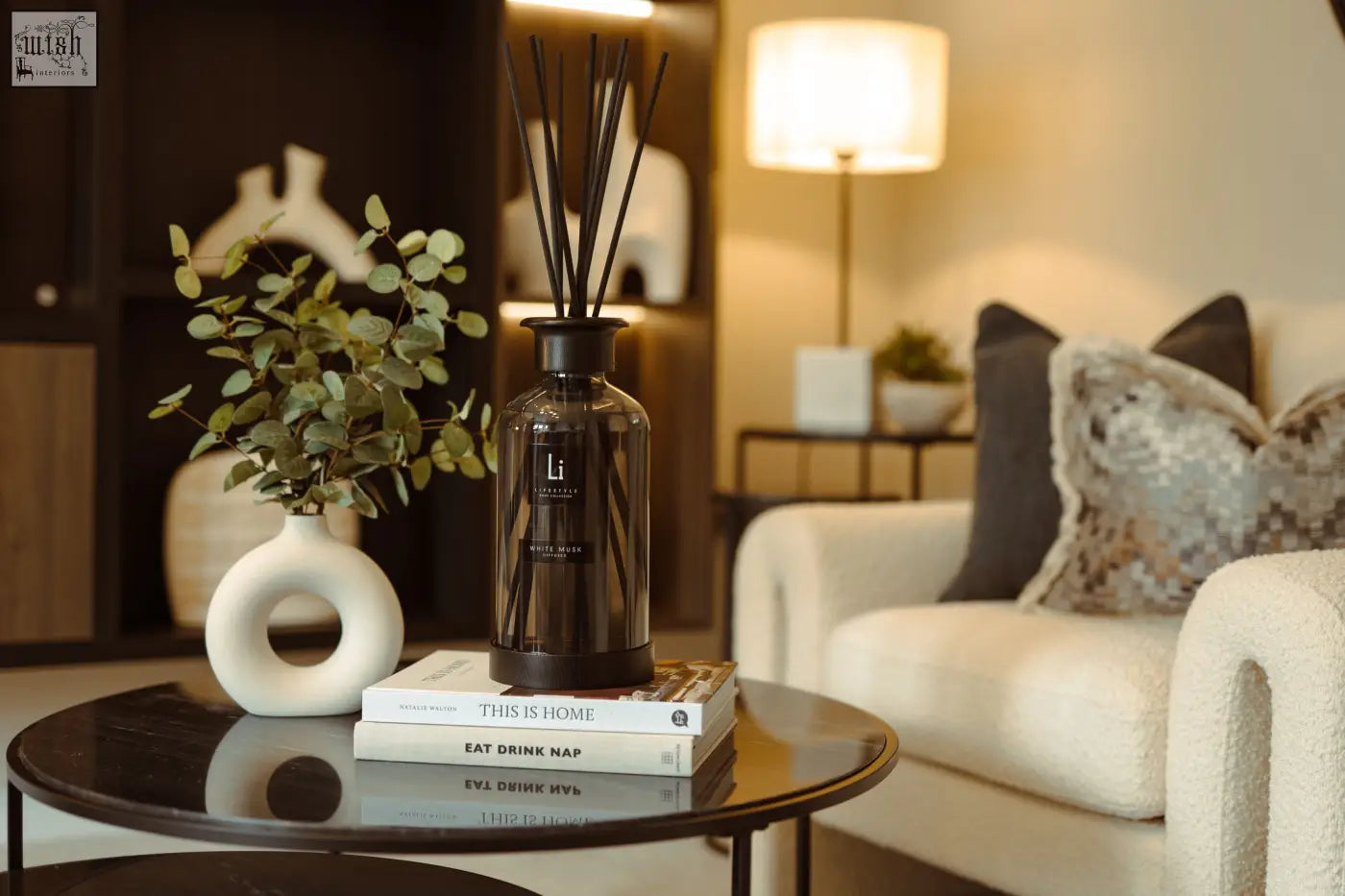 Dark amber glass luxury xxl room diffuser with black reeds and minimalist label scented with white musk
