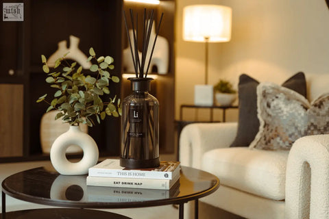 Dark amber glass luxury xxl room diffuser with black reeds and minimalist label scented with white musk