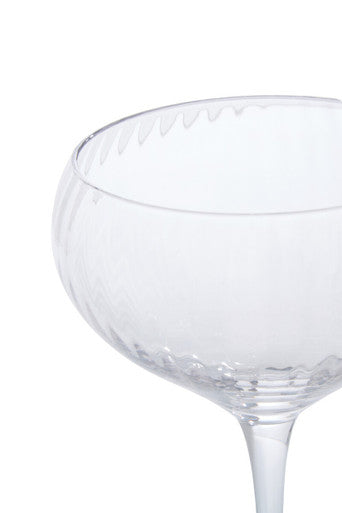 Clear glass coupe cocktail glass with textured faceted rim and stem from the lyle set of four cocktail glasses
