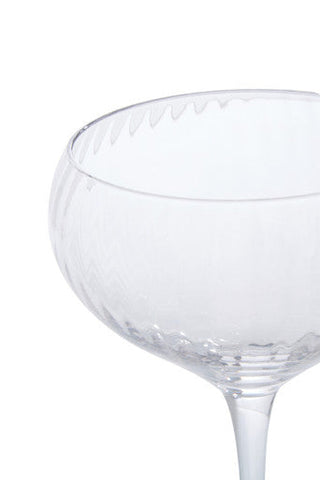 Clear glass coupe cocktail glass with textured faceted rim and stem from the lyle set of four cocktail glasses