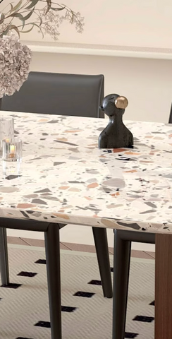 Black abstract figurine with gold spherical accent displayed on lynette dining table terrazzo oval dining table surface