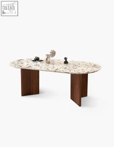 Elegant oval lynette dining table with speckled terrazzo top and sleek dark wood legs perfect as a terrazzo dining table