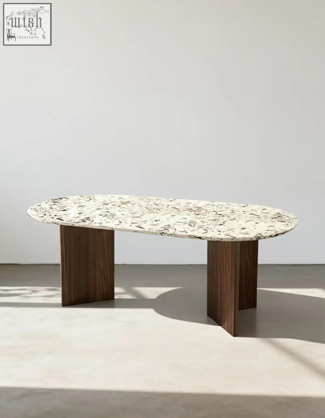 Elegant lynette dining table with a speckled white and gray terrazzo top and sleek dark wood legs perfect as a dining table