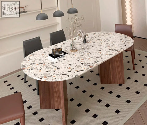 Elegant lynette dining table with white terrazzo top speckled in black gray and beige on sleek wooden legs