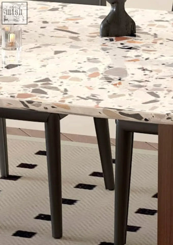 Lynette dining table is a terrazzo dining table with a white base and gray beige muted orange speckles perfect for eating