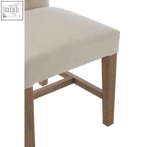 Beige linen lyon dining chair with wooden legs and soft beige linen upholstery perfect for dining rooms